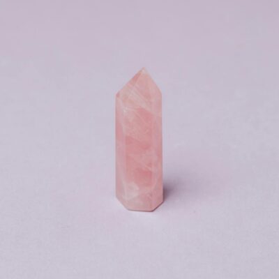 Closeup of pink quartz natural stone obelisk polished in jewelry workshop
